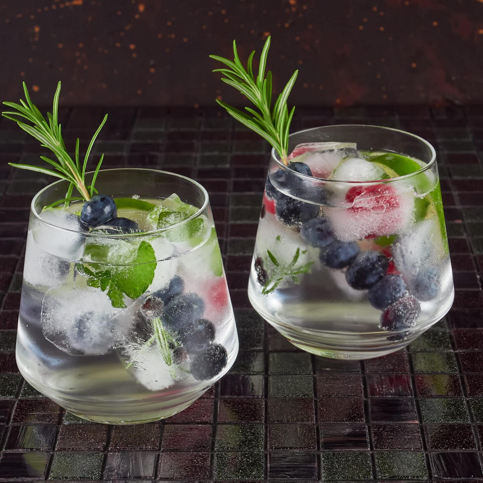Gin tonic cocktail Gin tonic decorated with a rosemary sprig and fresh berries