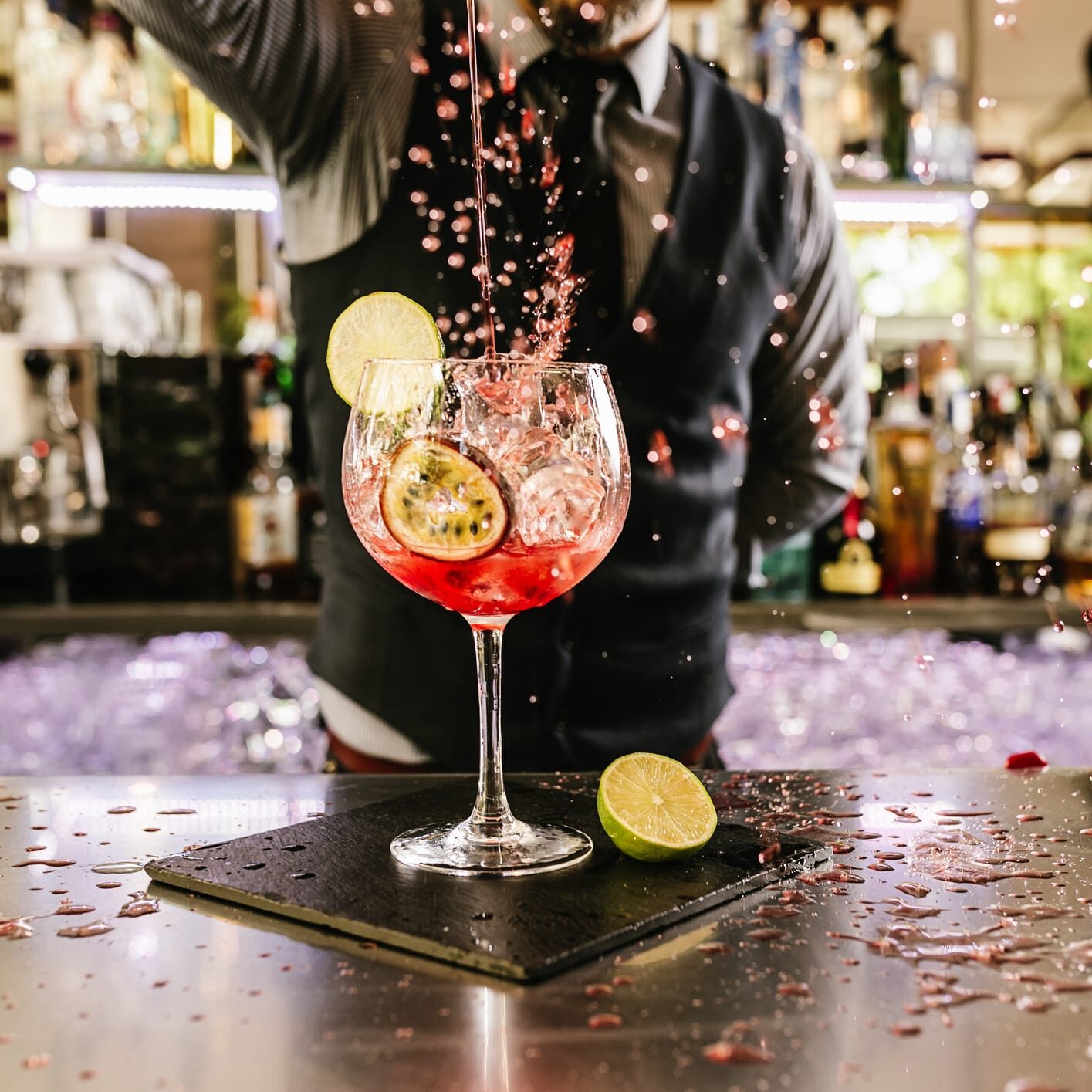 Expert barman is making cocktail at night club.